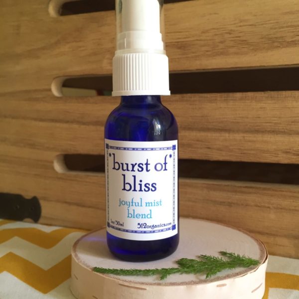512organics bottle of 1 oz Burst of Bliss essential oils misting spray with wood background